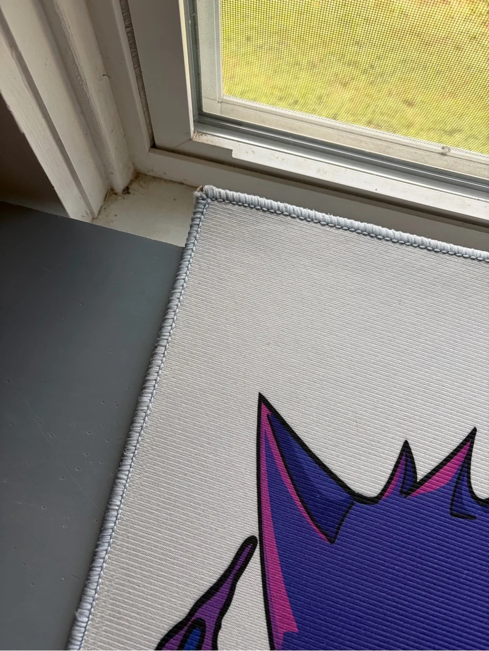 White Bath Mat with Purple Character Graphic
